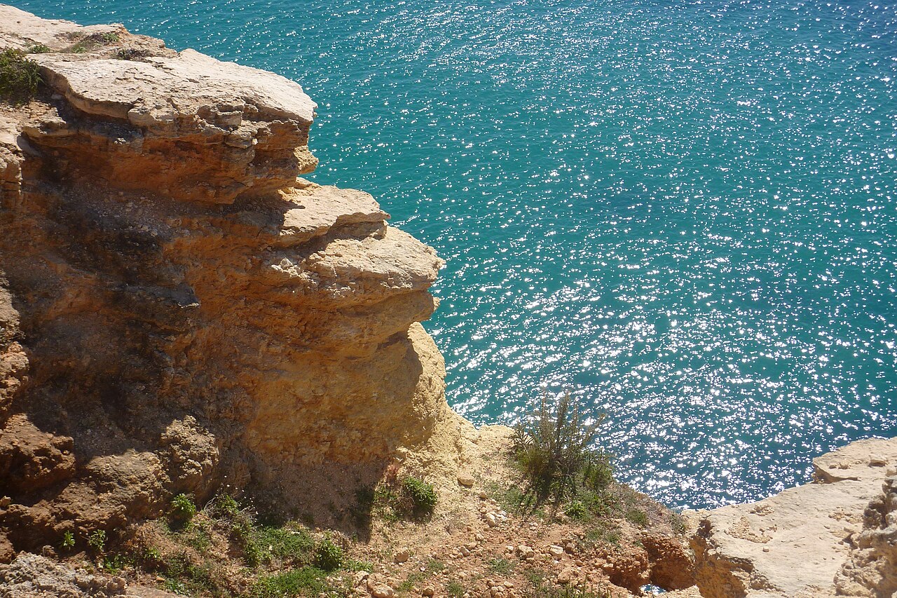 Golden limestone cliffs above the turquoise sea of the Algarve